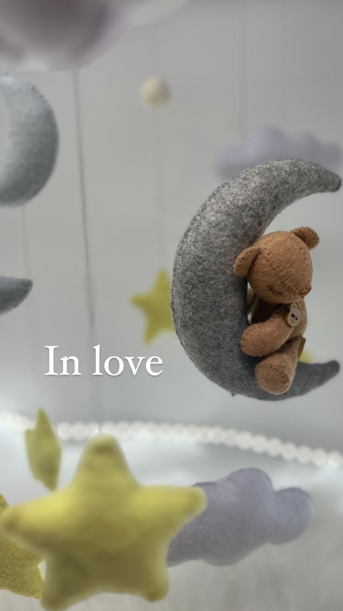 Personalised floating baby mobile in felt with adorable handmade stars, clouds and a tiny teddy bear