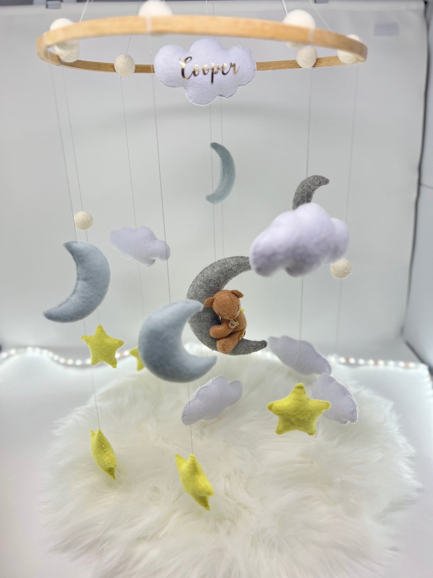 Personalised floating baby mobile in felt with adorable handmade stars, clouds and a tiny teddy bear