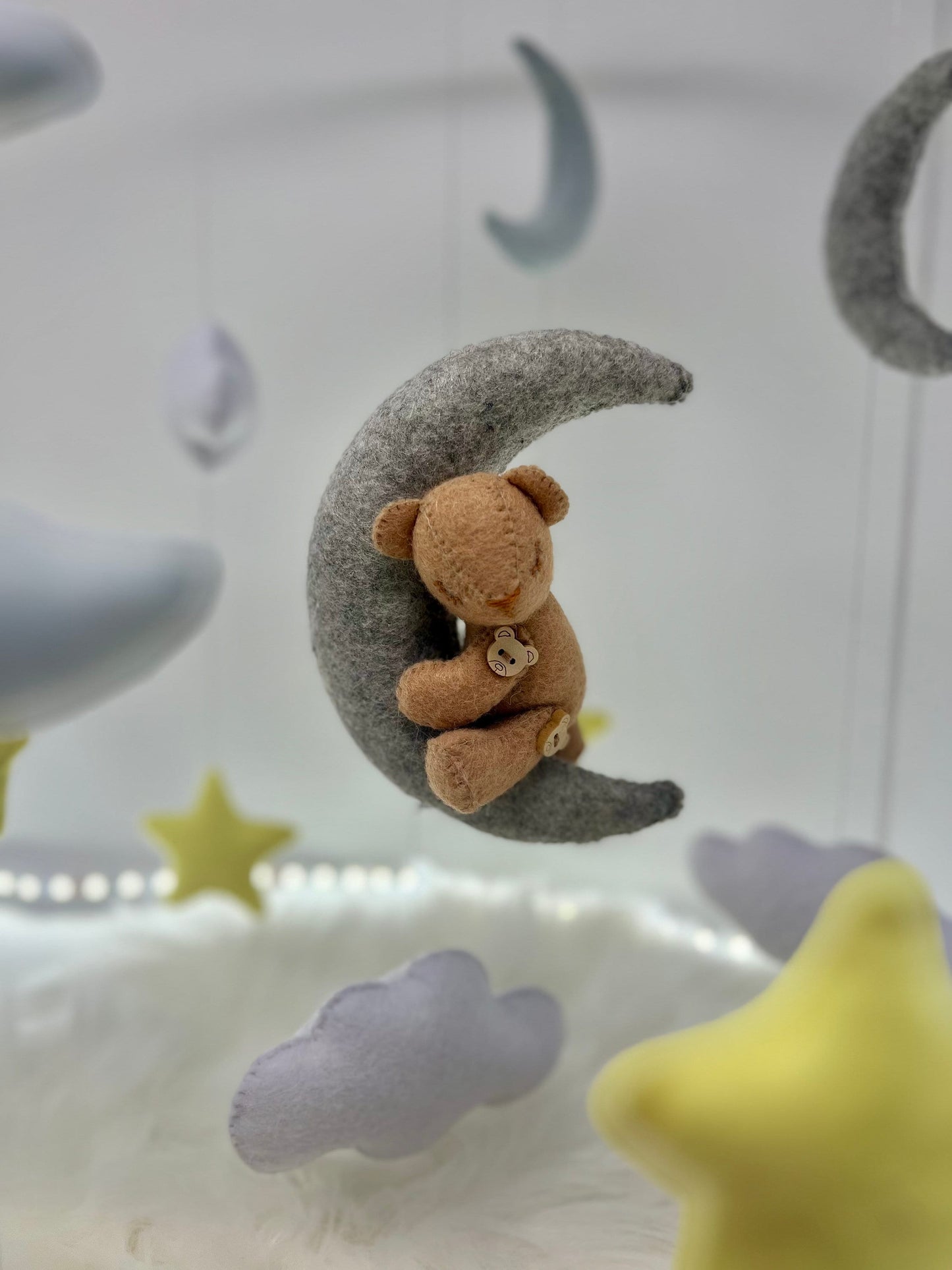 Personalised floating baby mobile in felt with adorable handmade stars, clouds and a tiny teddy bear
