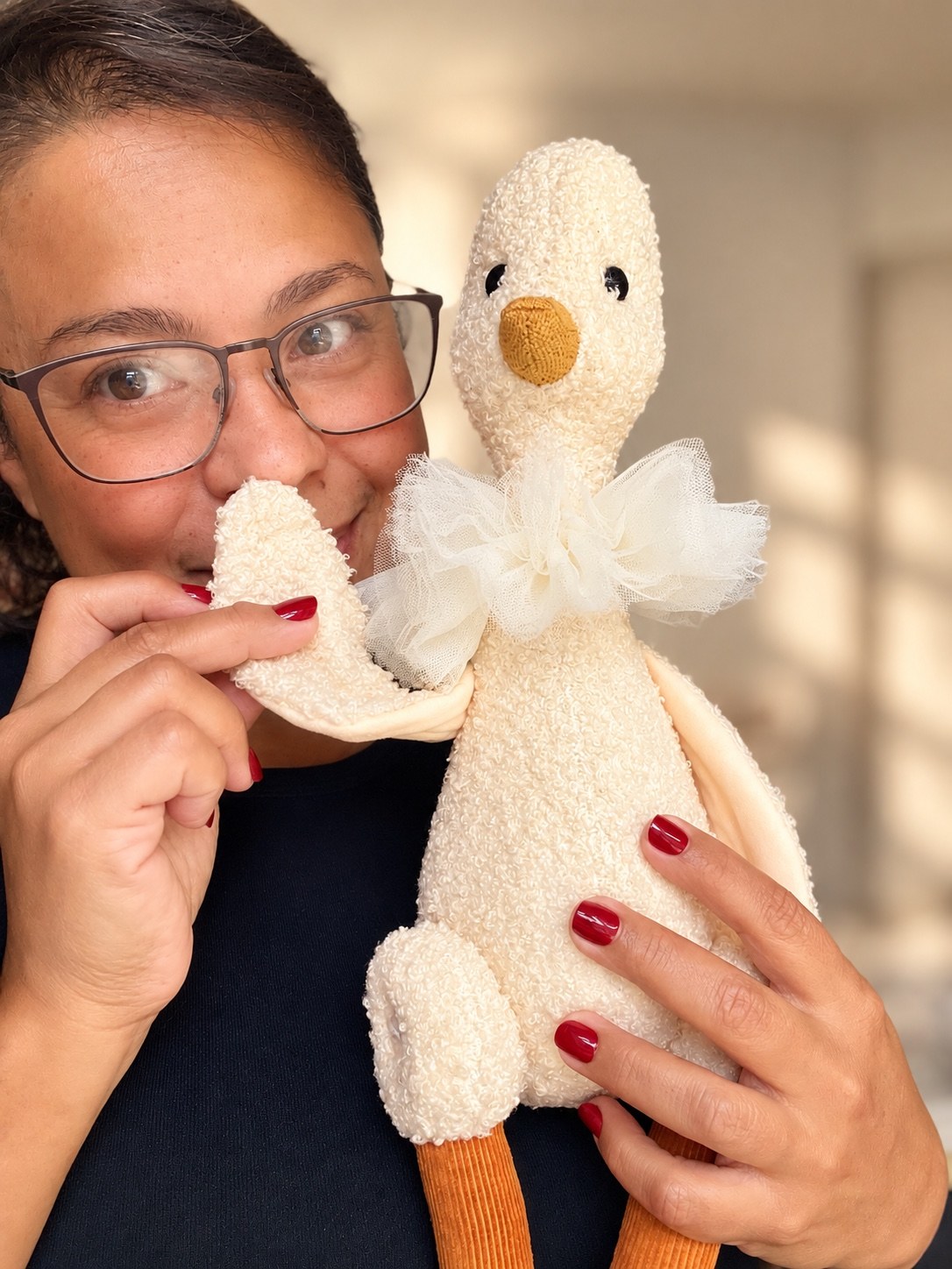 Melissa holding her handmade cream duck